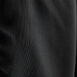 Close-up of black activewear jacket lounge hoodie fabric, showcasing recycled material texture and quality stitching.