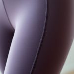 Close-up of flare leggings woman high rise compression leggings fabric texture and stitching detail.