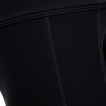 Close-up of high waisted yoga pants fabric showing texture, stitching, and quality in black leggings.