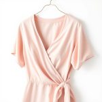 Pastel pink bamboo wrap top, an eco conscious womens fashion top on white background.