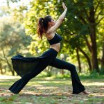A woman in Black best flare leggings performing a yoga pose in an Australian park.