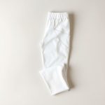 White organic knit fabric circuit yoga pants folded flat lay.