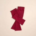 Burgundy cotton yoga pants, flared leggings folded flat on a neutral surface.