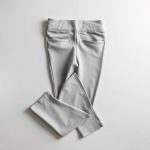 Flat lay of Heather Grey flare leggings petite, workout leggings with pockets, neatly folded on a neutral surface.