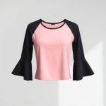 Pastel Pink flares black yoga top on a clean white studio background.