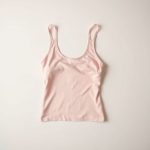 Flares black yoga top in Pastel Pink folded neatly on a clean surface.