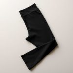 Flat lay of Black hot yoga pants raspberry leaf te, neatly folded on a neutral surface.