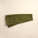 Neatly folded olive green low rise flare leggings made from bamboo fabric, flat lay.