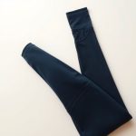 Navy Blue maternity yoga leggings with pockets, neatly folded in a flat lay on a neutral background.