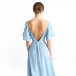 Back view of a model wearing the Sky Blue moon dress by Laguna Clothing on a white background.