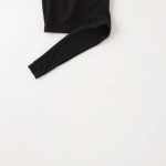 Black running leggings for women with pockets, neatly folded in a flat lay on a neutral background.