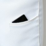 Close-up of linen fabric and stitching on white flare leggings with phone pocket, highlighting texture and quality.