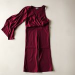 Burgundy wide leg yoga pants and lululemon wrap top folded on a neutral surface.