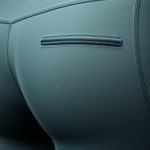 Close-up of the fabric texture and stitching on workout pants with pockets and scrunch bum leggings, highlighting quality material.