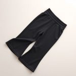 Charcoal organic activewear yoga flared pants folded on a clean surface.