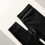 Black yoga flares in Ecovero fabric, neatly folded in a flat lay.