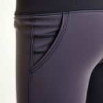 Close-up of high-quality fabric and stitching on womens yoga pants with activewear pockets.