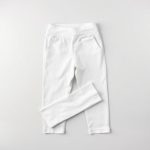 White yoga pants womens with pockets, neatly folded on a neutral surface, top-down flat lay view.