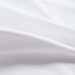 Close-up of white yoga tanks workout top showing moisture-wicking Performance Fabric texture and stitching detail.