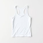 White yoga tanks neatly folded on a clean surface, minimalist flat lay workout tank top.