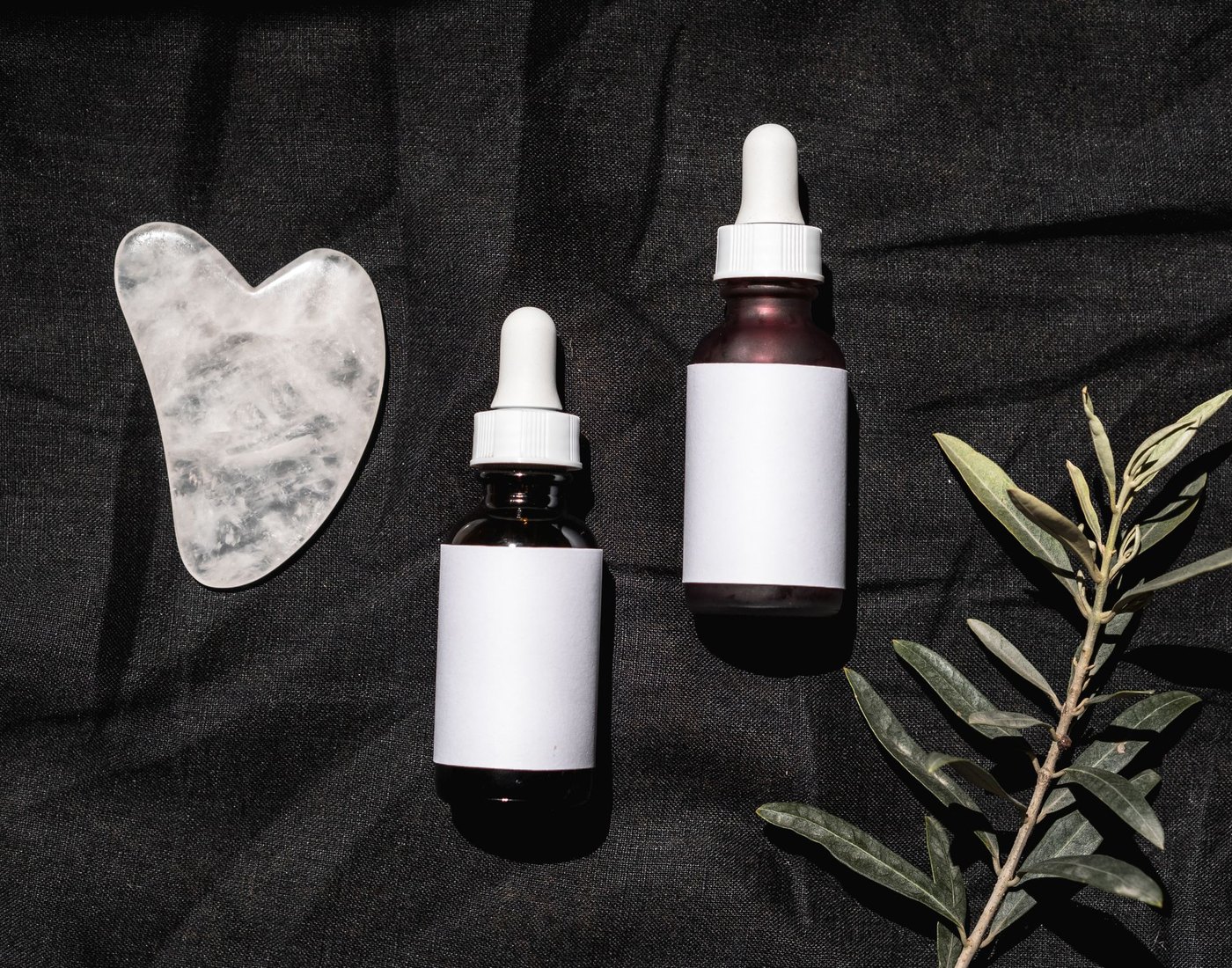 ORIVEA serum bottles with olive branch and gua sha